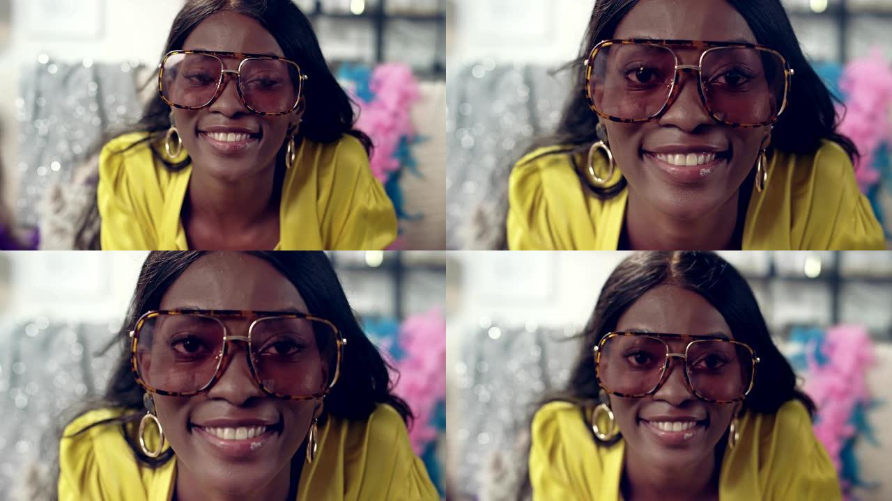 非洲种族女性对着相机做鬼脸。有趣的眼镜