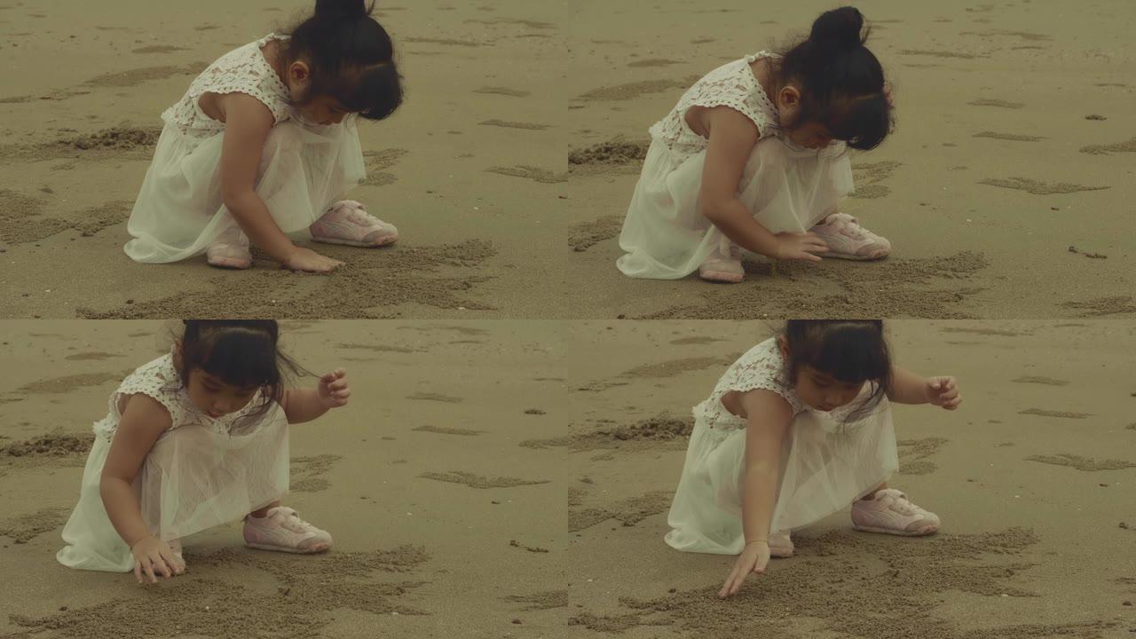 玩沙子的小女孩小女孩玩耍沙滩