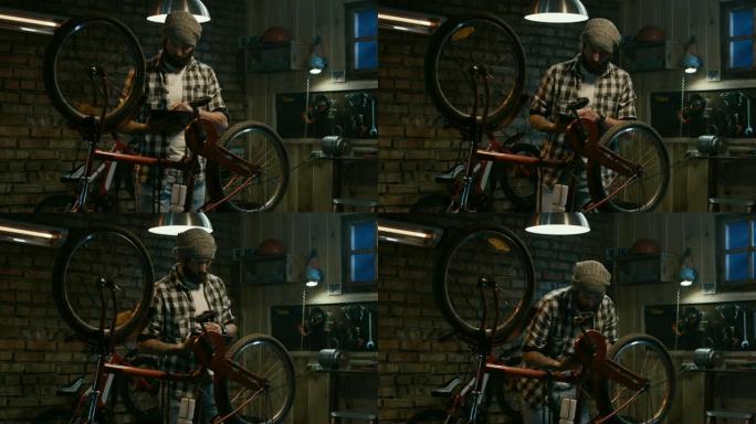 男子在自行车维修店使用平板电脑