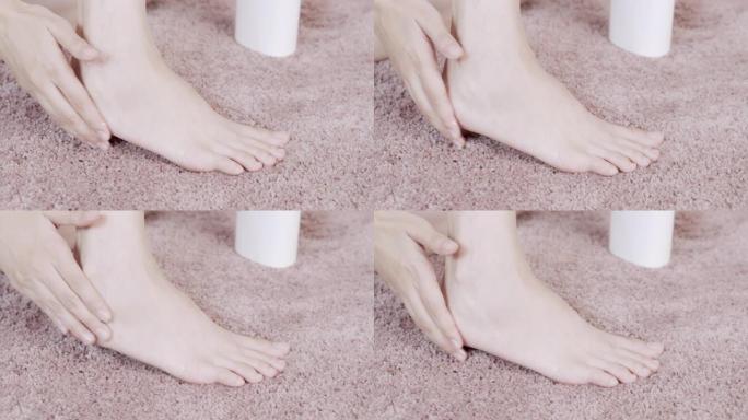 亚洲成年女性用手在脚上涂抹保湿霜。身体护理概念。