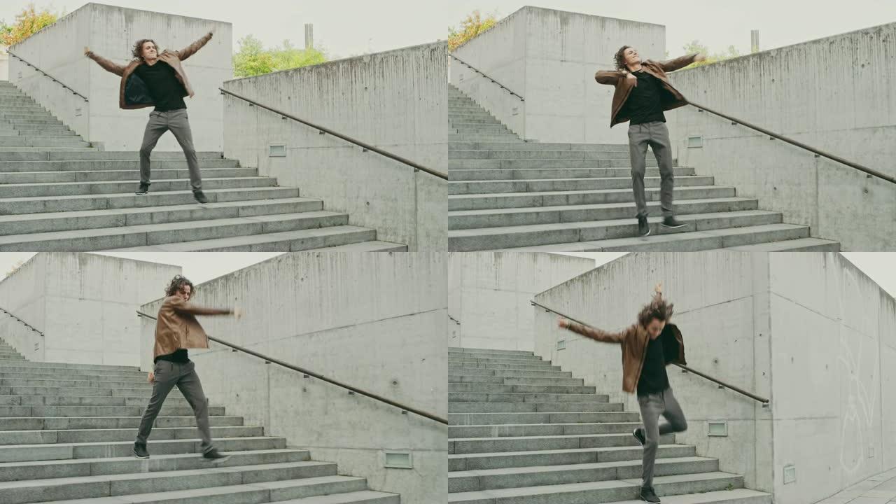 开朗快乐的长发年轻人在走下楼梯时积极跳舞。他穿着一件棕色皮夹克。在城市混凝土公园拍摄的场景。天很亮。
