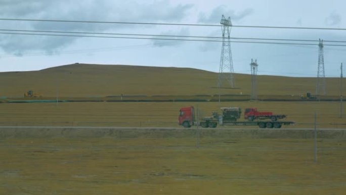 电线阻碍了卡车驶过西藏平原的视线