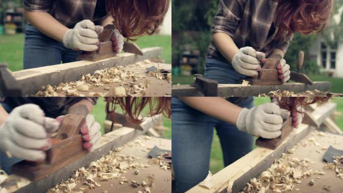 花园DIY。刨木家具的女人。