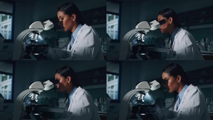 深色皮肤的肖像女科学家正在实验室用显微镜分析样本以提取DNA和分子