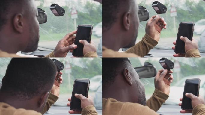 参与车祸的男性驾车者从行车记录仪转移镜头以进行保险索赔