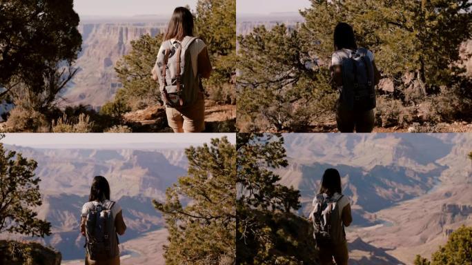 快乐活跃的年轻女子背着背包徒步旅行，观看大峡谷慢动作令人惊叹的夏季全景风景。