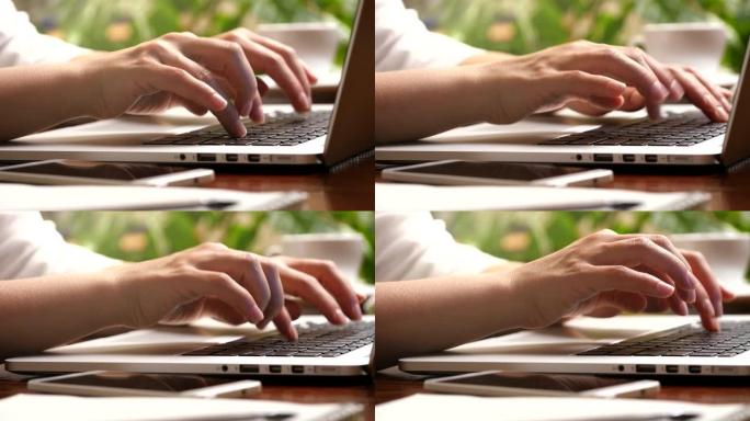 女性手指按下按钮并在笔记本电脑上打字的滑动镜头。在家网上工作的女人。UHD