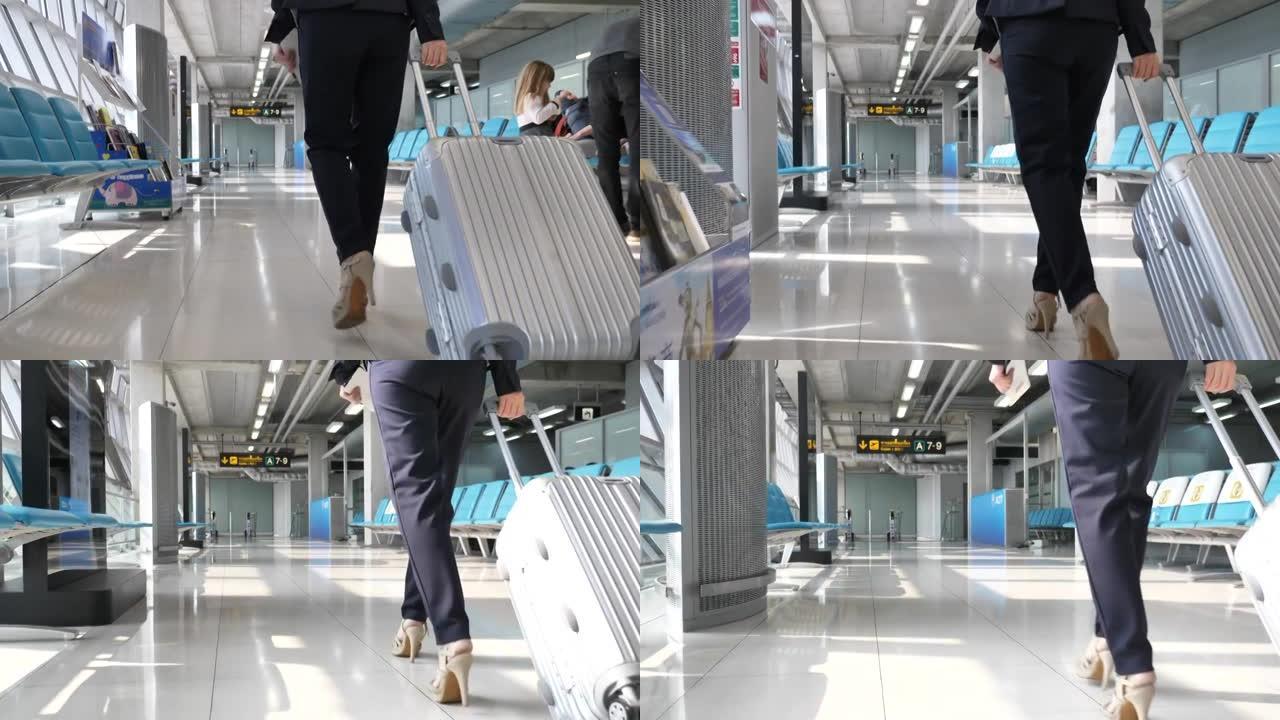 女商人带着手提箱在机场散步，商务旅行