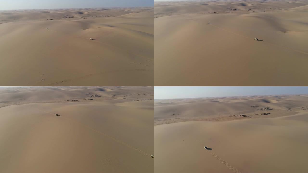 纳米比亚纳米布沙漠骨架海岸沙丘上行驶的4x4车辆的4k高鸟瞰图