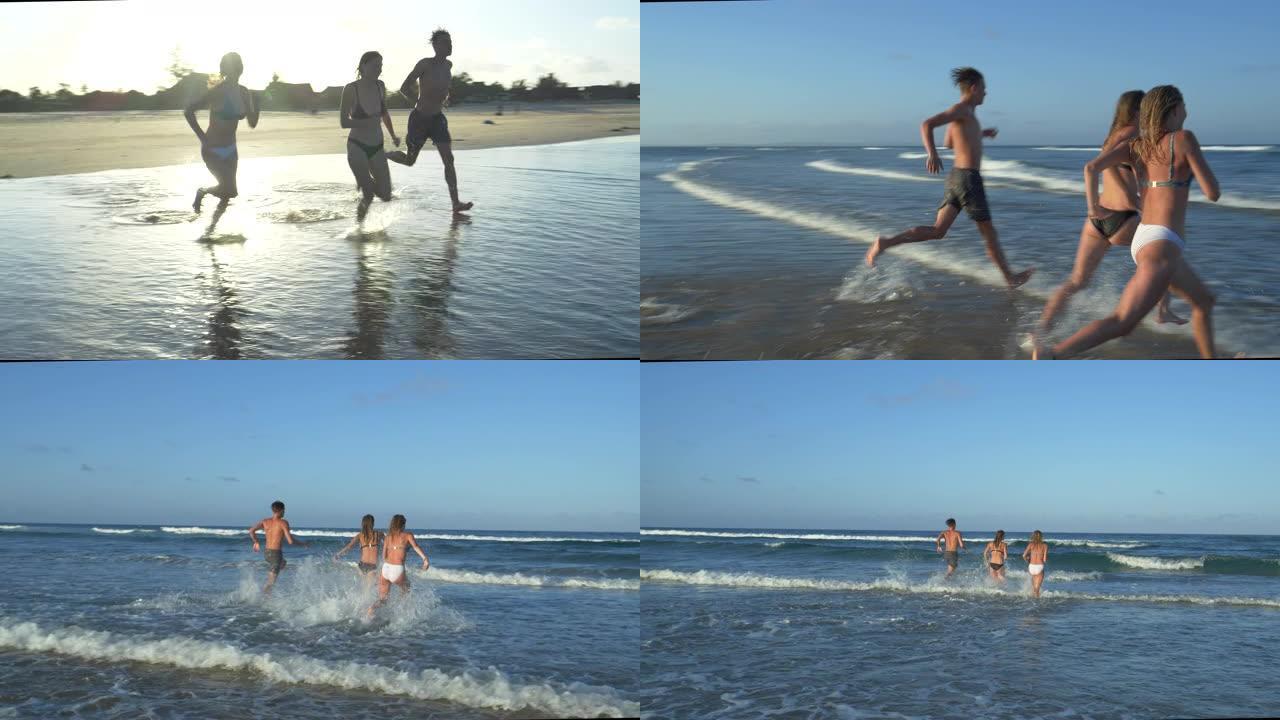 南非，两个美丽的年轻女子和一个年轻男子笑着跑出大海的4k后视图