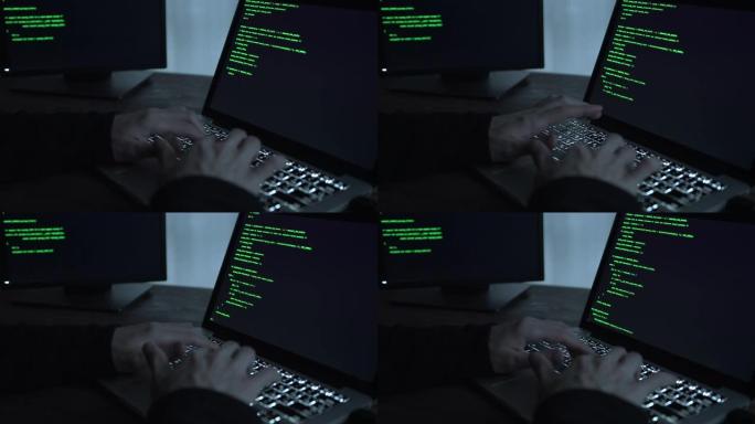 笔记本电脑上的人的手编码特写了。使用便携式计算机的人。Man程序员编写代码