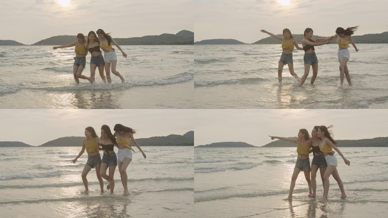一群亚洲年轻女性在海滩上散步，朋友们快乐放松，晚上日落时在海边的海滩上玩耍。生活方式朋友旅行假期假期