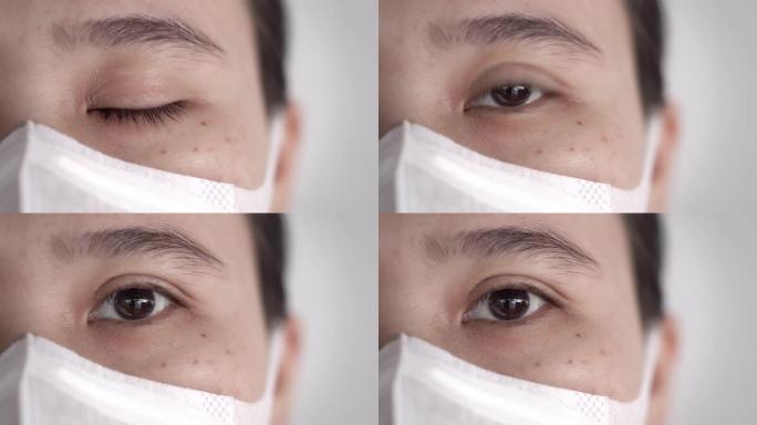 用卫生口罩或医用口罩看着相机的亚洲女性眼睛特写