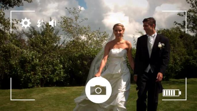 在数码相机上拍摄新娘和新郎的照片