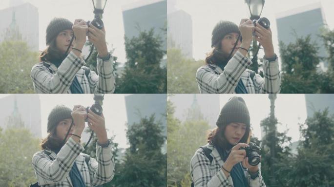 年轻的亚洲女性在中央公园用数码单反相机拍摄图像。纽约