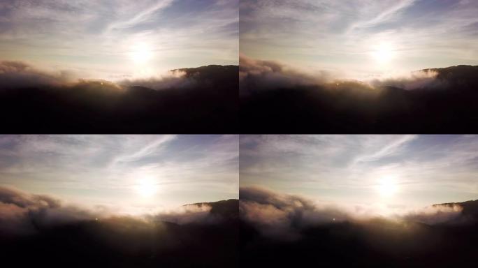 日出时山上云和天空的鸟瞰图，多莉从右向左拍摄