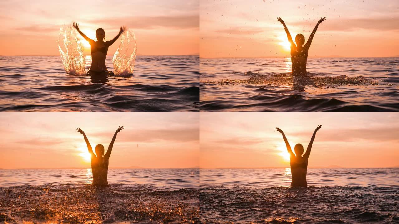 女人在海洋中玩耍，暑假期间在空中泼水