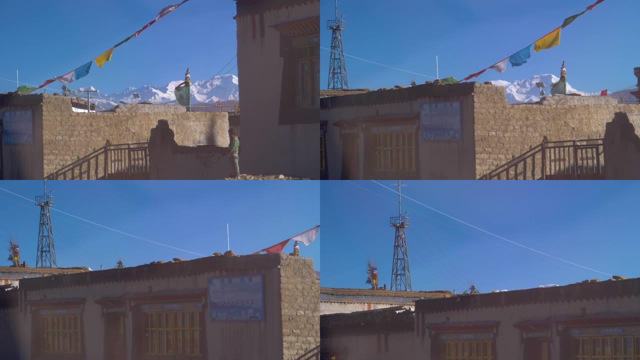 慢动作: 穿越西藏一个带有祈祷旗的乡村。
