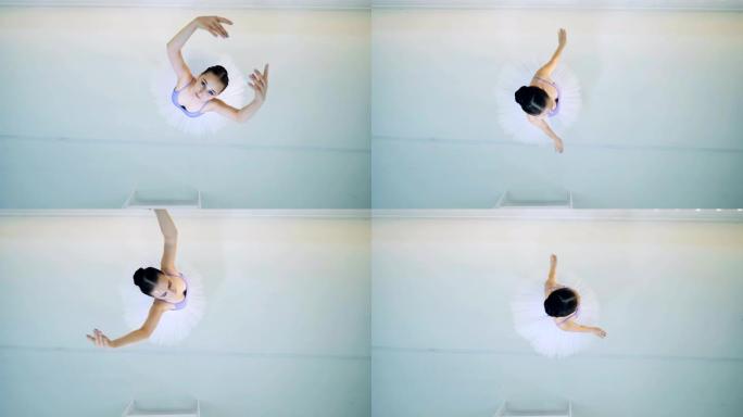 女芭蕾舞演员在俯视图中表演旋转动作