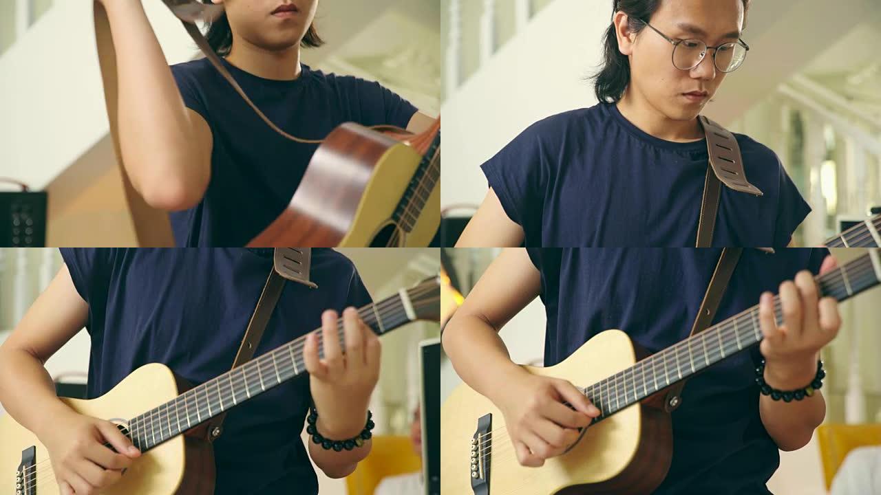 年轻的亚洲男吉他手准备演奏