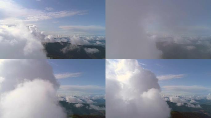 美丽群山上空的云层飞行。过度下垂