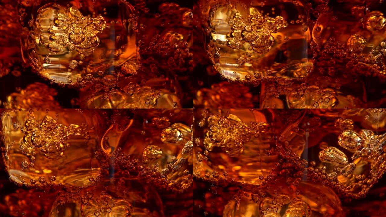 旋转的可乐杯中带有气泡的冰块。抽象超级特写镜头，UHD