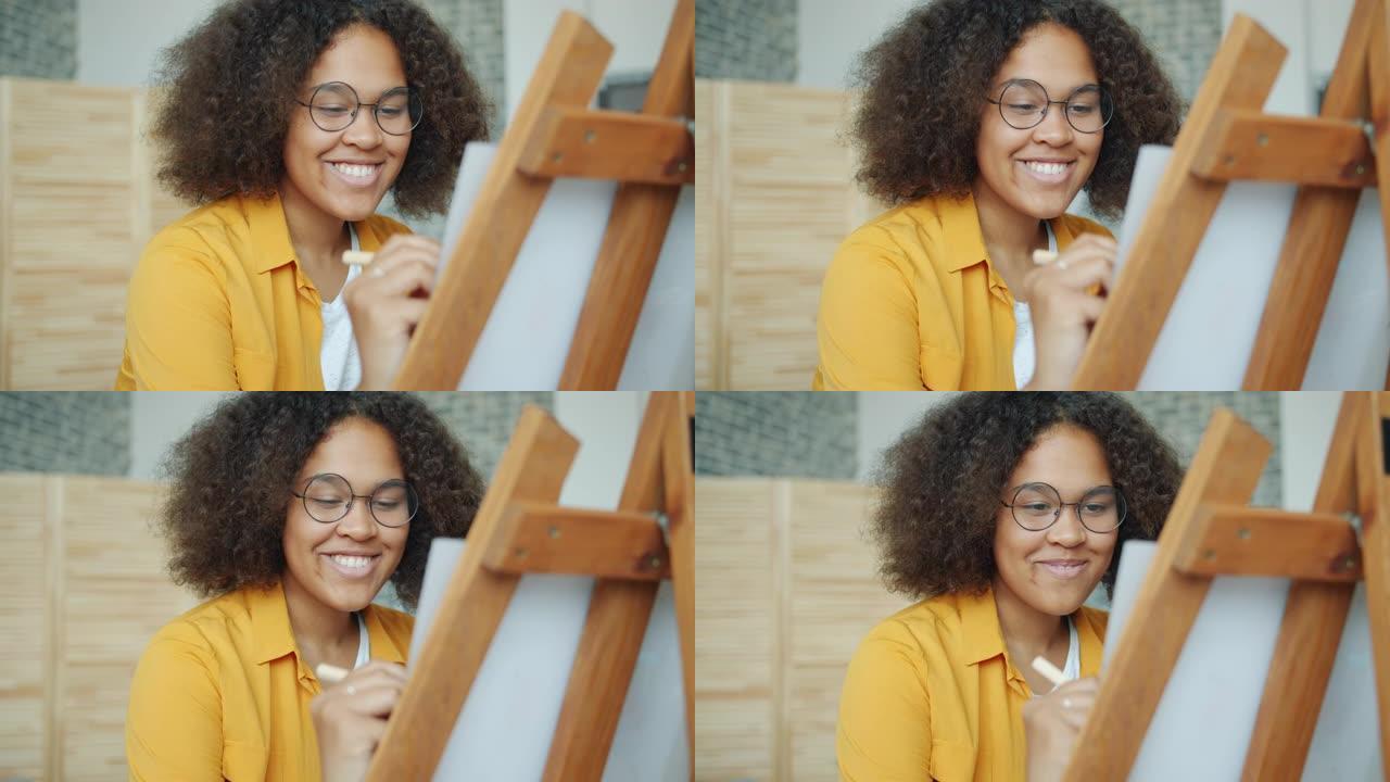 快乐的非洲裔美国少年在家画画微笑享受爱好