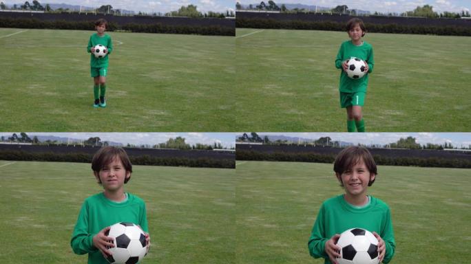 一个足球孩子队的开朗守门员走到镜头前，拿着球对着镜头微笑