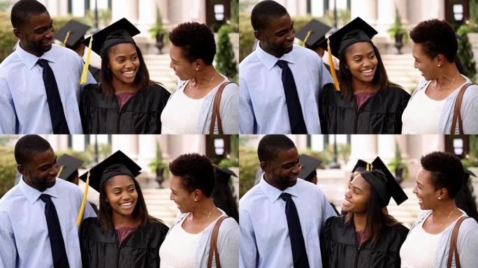 兴奋的大学毕业生毕业典礼后与父母交谈