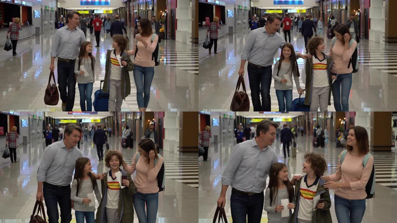 美丽的家人带着护照和登机牌在机场散步