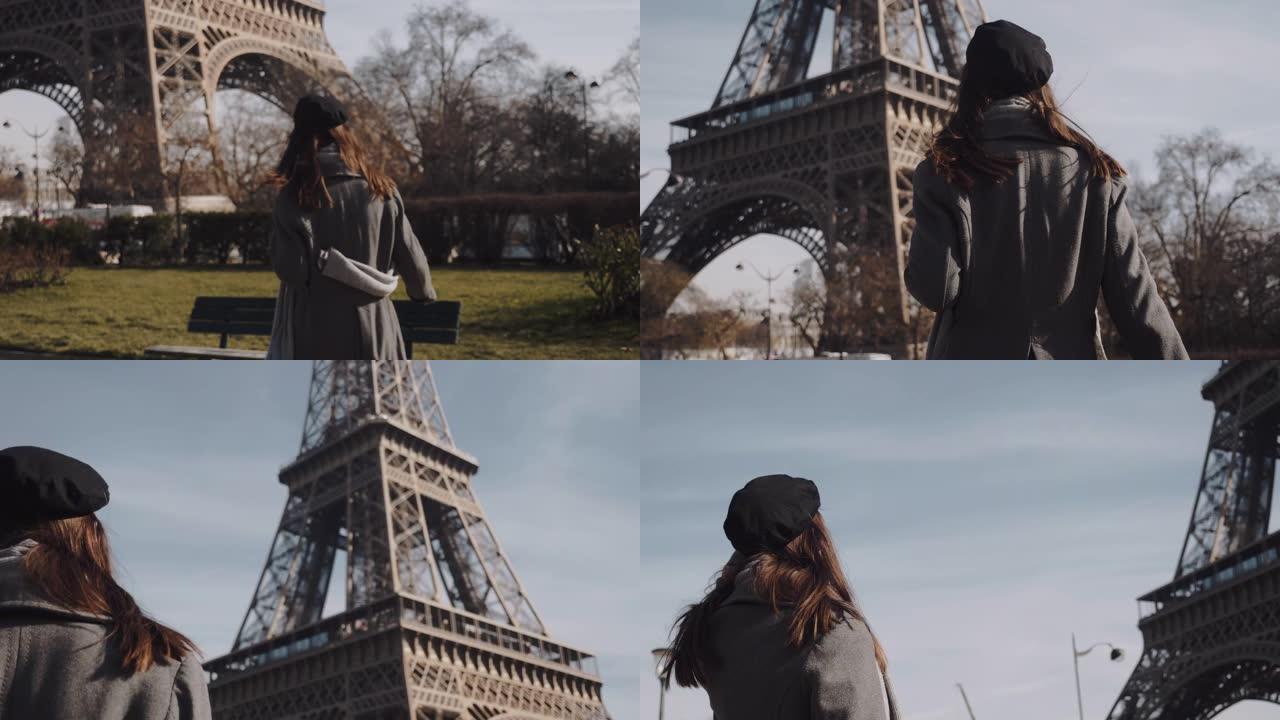 镜头跟随美丽快乐的旅游女人奔向埃菲尔铁塔，回头看着镜头慢动作微笑。
