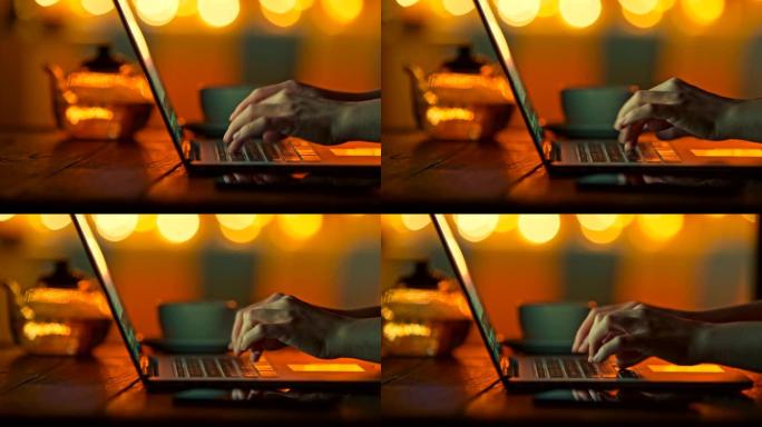 在半标记温暖的环境中，女性手指在笔记本电脑上打字。明亮的黄色圆形bokeh背景。滑动镜头，4K