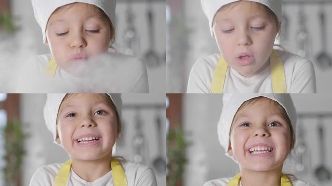 一个小女孩在厨房里打扮成专业厨师玩面粉的肖像，弄脏了她的手，开心地微笑。
