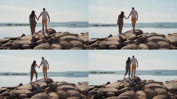 在岩石上行走的时尚夫妇