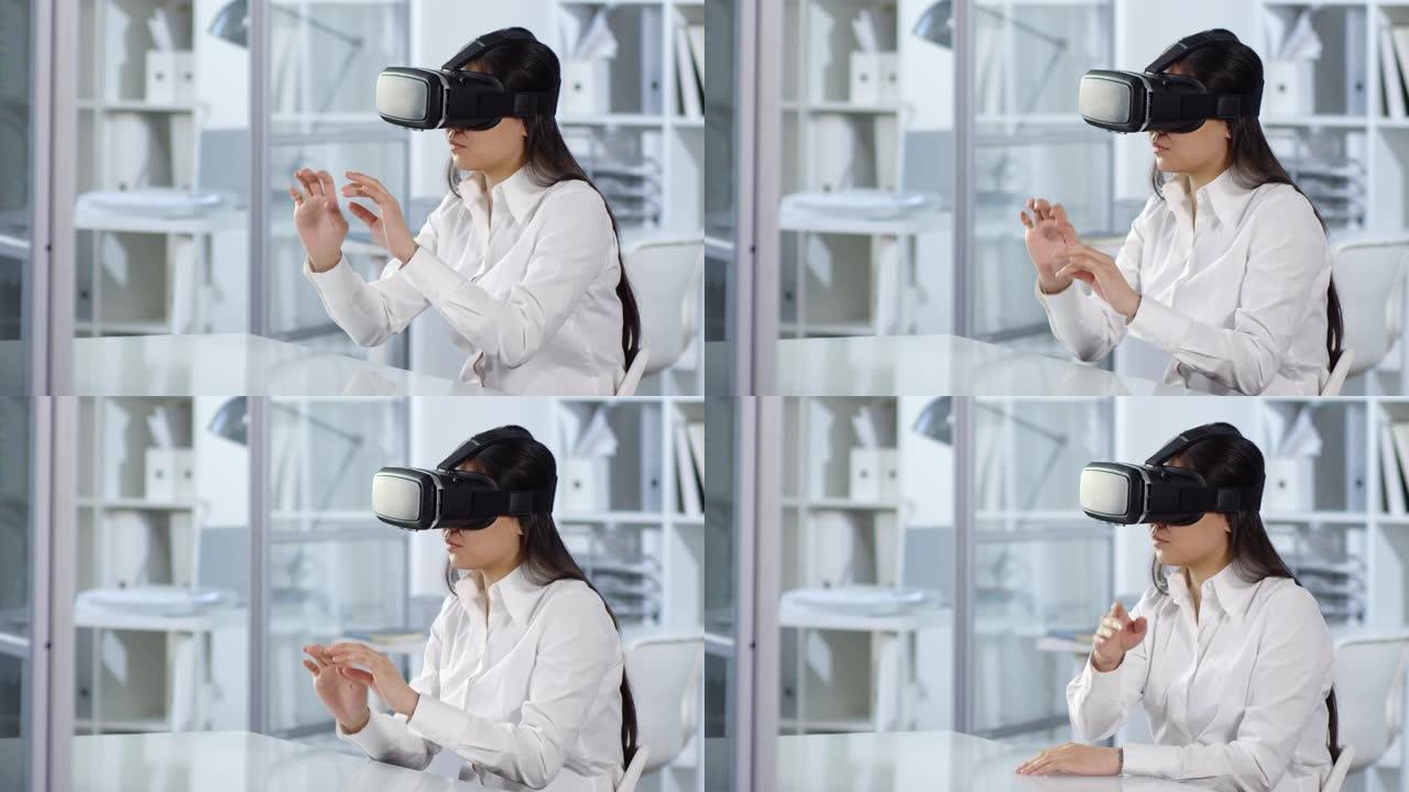 在办公室使用VR耳机工作的亚洲女性