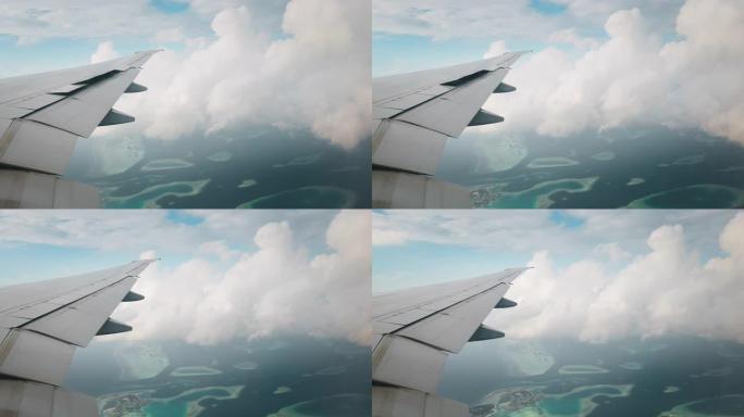 飞机机翼的缓慢运动和从飞机光源与云和岛屿的全景视图