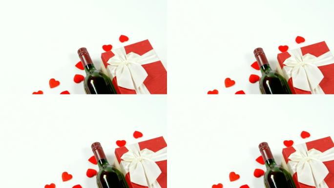 酒瓶、礼品盒和白色表面散落的红心4k