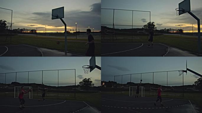 WS年轻人在黄昏时在室外篮球场上打篮球