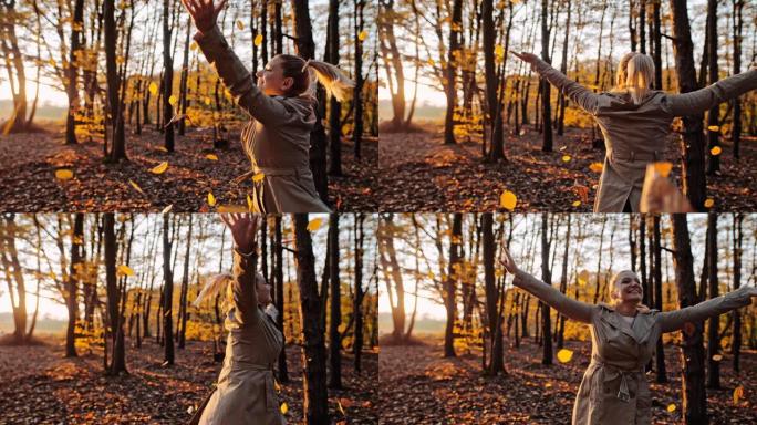 MS超级慢动作无忧无虑的年轻女子在森林里玩金色的秋叶