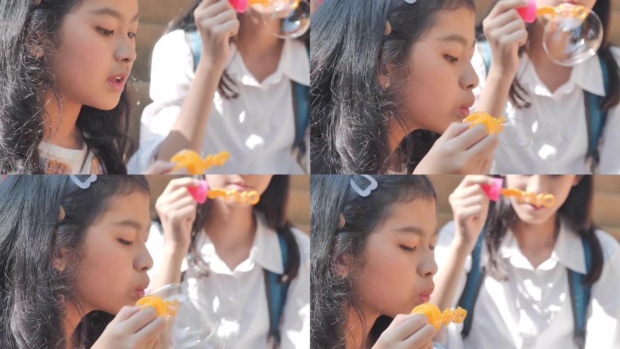 亚洲团体少女放学后在春天公园或夏天吹肥皂泡的乐趣。