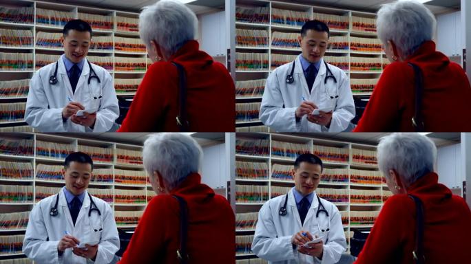 年轻的亚洲男医生在诊所为病人开药4k