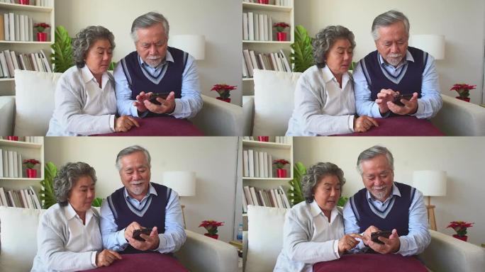 尝试学习使用手机的资深夫妇退休夫妇正在学习使用现代设备与头晕是时代的不同。过去学会了使用现代产品