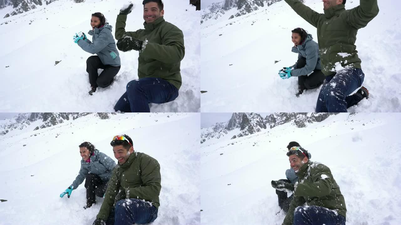 快乐的夫妇在雪地战斗中开心地笑