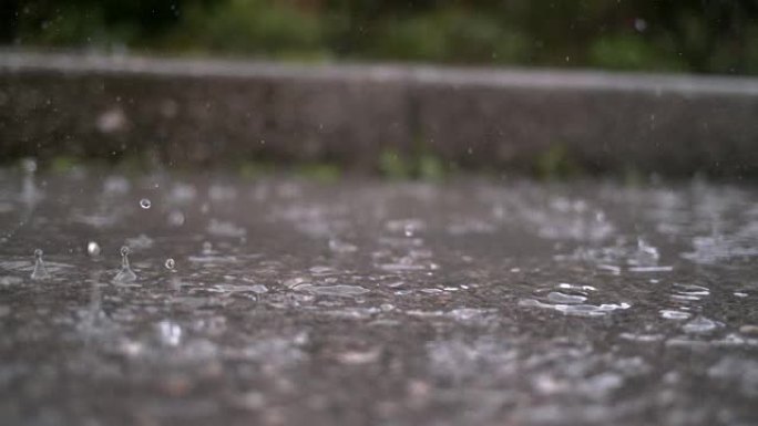 慢动作，特写: 秋天的雨滴落在街上的水坑中