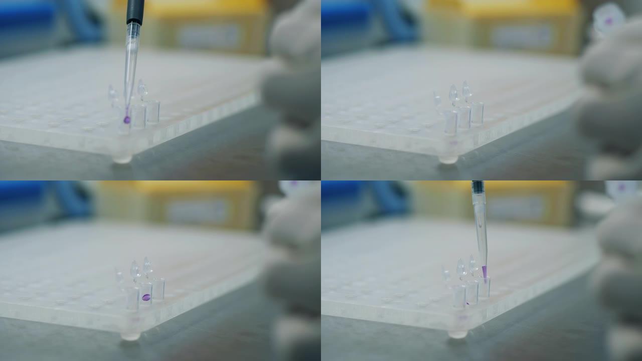 实验室工作人员将滴剂放入试管中。