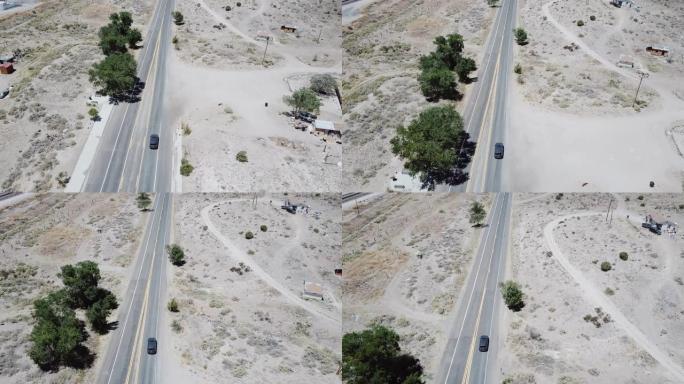 无人机跟随银色汽车在美国亚利桑那州夏季炎热的荒凉砂岩沙漠公路上行驶。公路旅行概念。