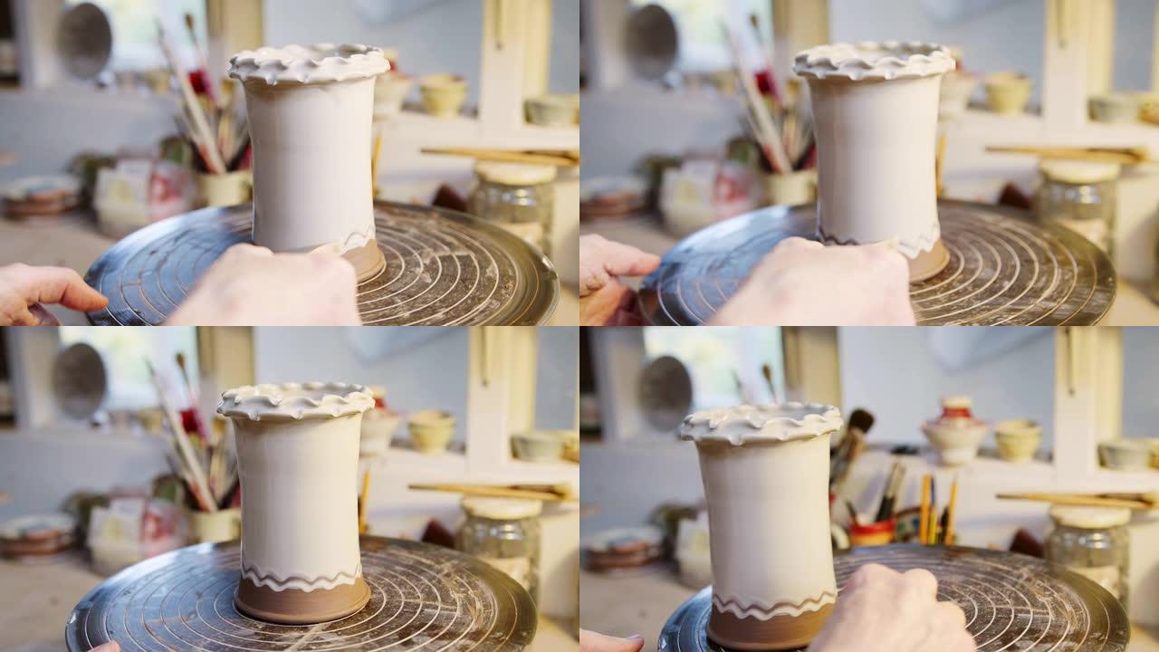 陶瓷工作室粘土花瓶上釉男性陶工设计特写
