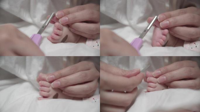 母亲在刚出生的婴儿上剪指甲