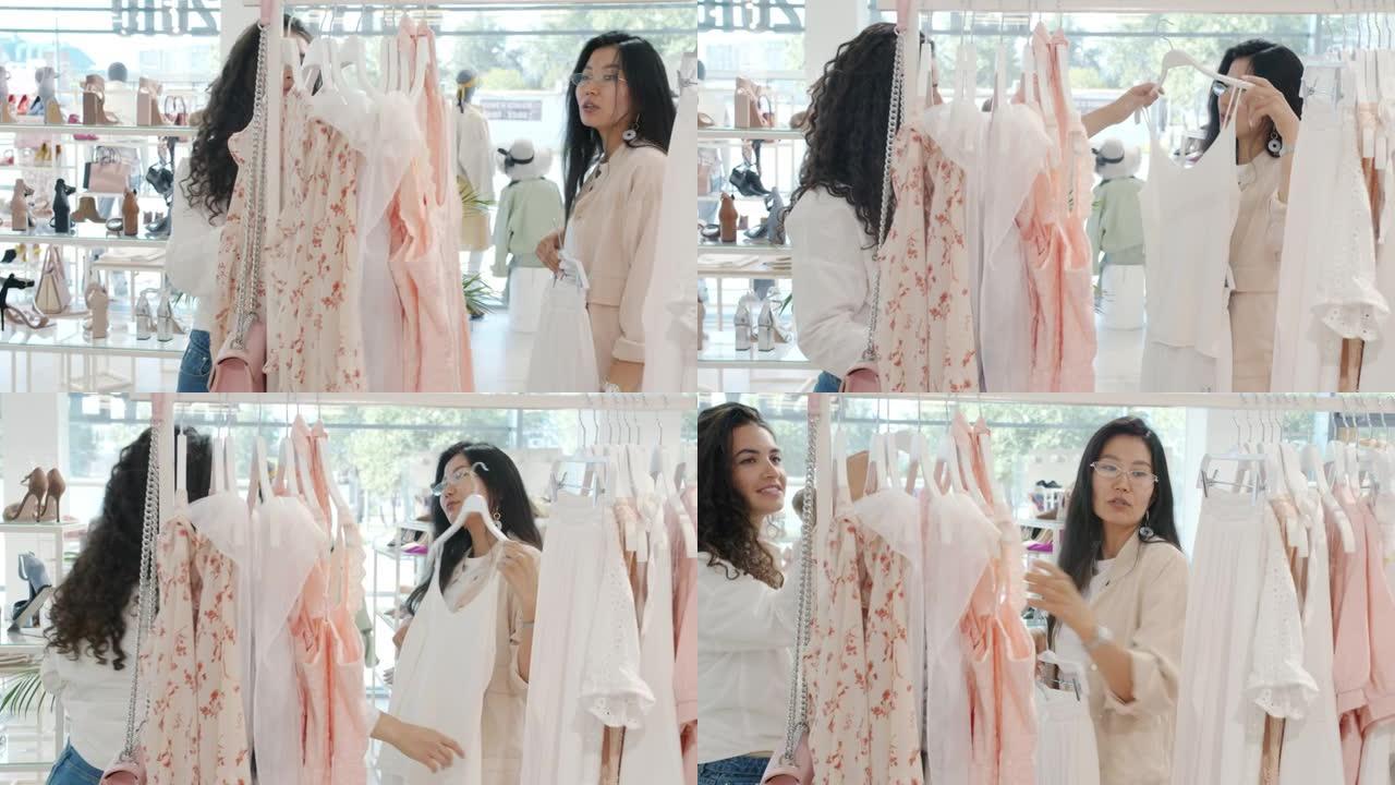 优雅的亚洲女性购物服装与平板电脑女售货员交谈