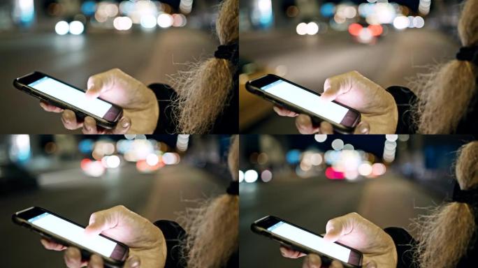 晚上在人行道上使用智能手机，留着长胡须的女士